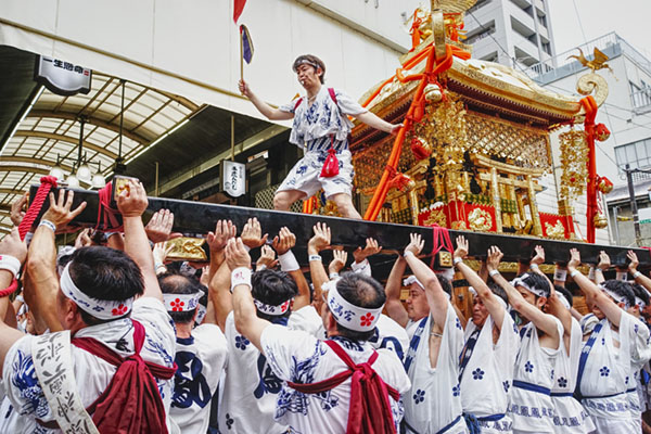 Osaka, Japan - July 25 2017: The traditional and historical Japanese festival Tenjin Matsuri in Osaka with thousands of attendants and specatators. Cloudy, but festive and colorful celebration.