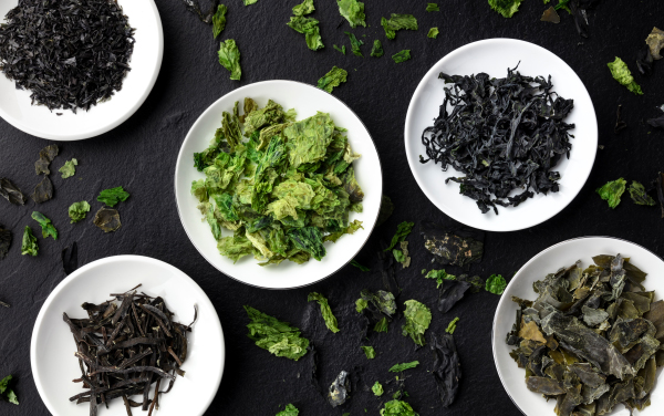 Various dry seaweed, sea vegetables, shot from above on a black background