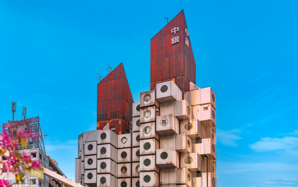 tokyo, japan - april 09 2021: Rusted corrugated sheet rooftop overlooking the famous cuboid Nakagin Capsule Tower building created in 1972 by Japanese architect Kisho Kurokawa in Shimbashi.