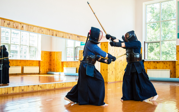 Close up of kendo fighter with shinai. Japanese martial art of sword fighting