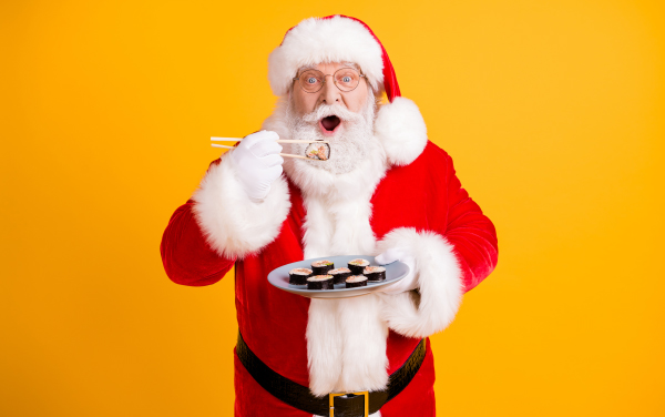 Portrait of his he nice cheerful funny hungry white-haired Santa enjoying eating domestic sushi sashimi roll maki weight loss recipe isolated bright vivid shine vibrant yellow color background