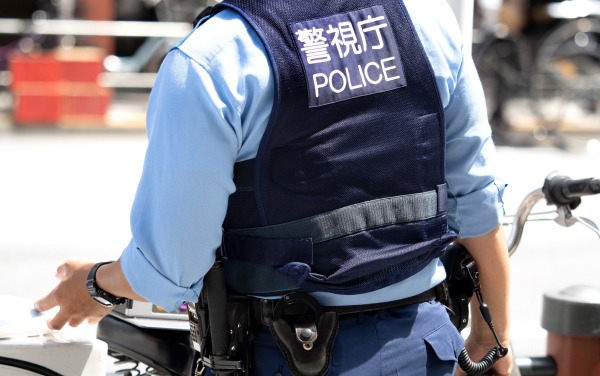 Taito Ward, Tokyo, Japan-July 2022: Police officers standing in the city